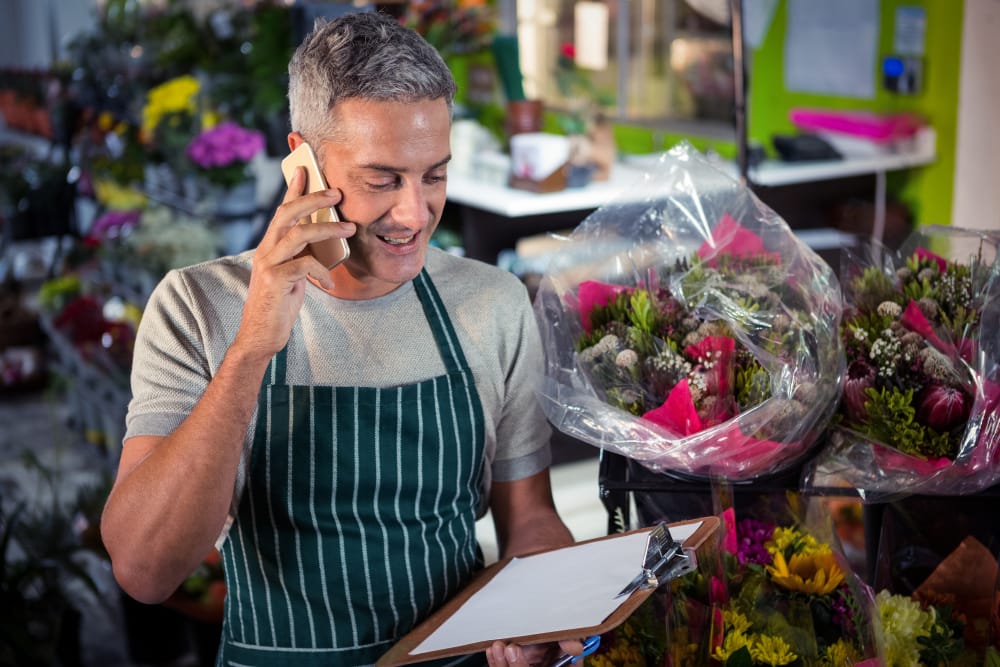 Wedding florist speaks by phone